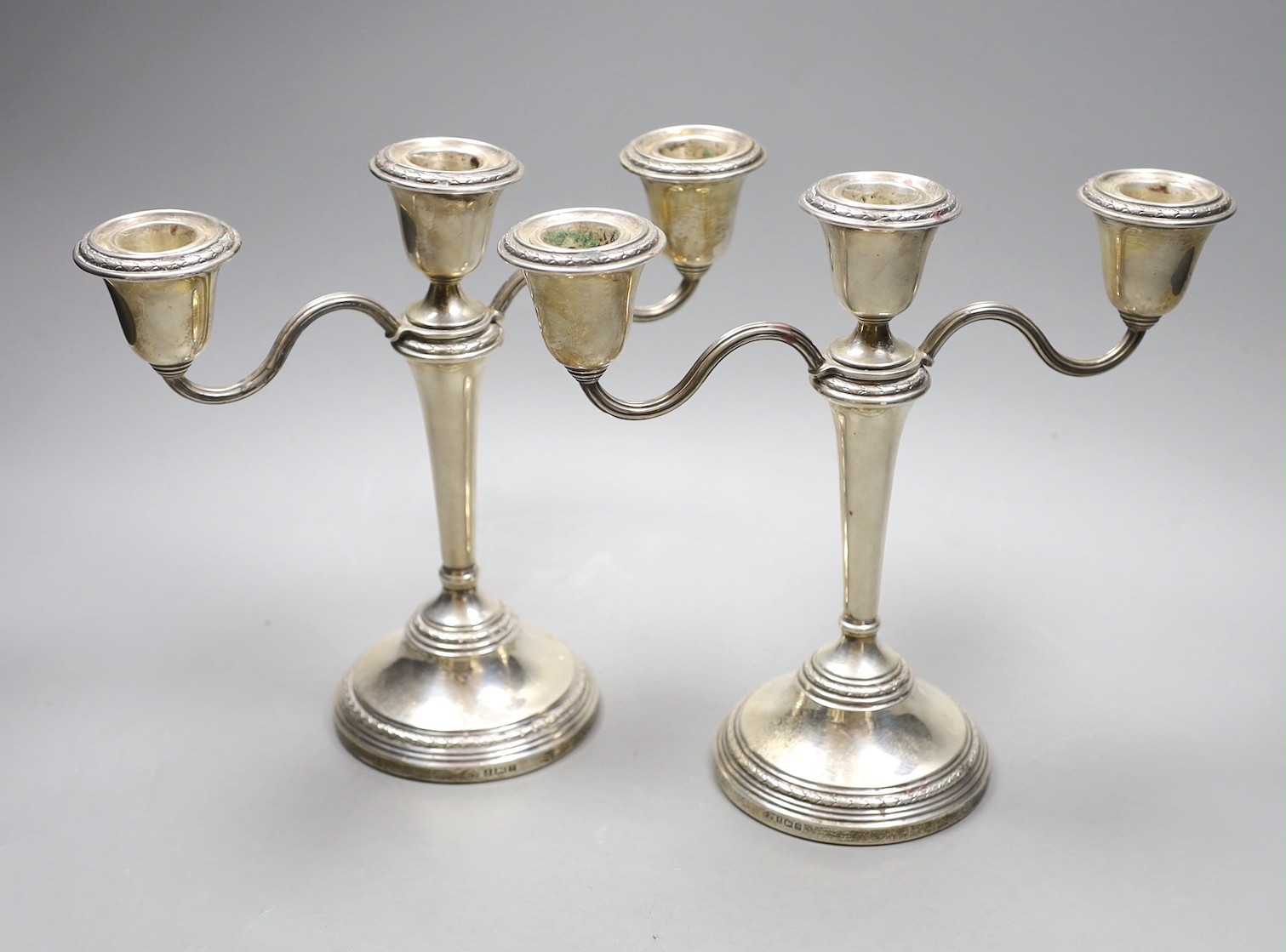 A pair of Elizabeth II silver candelabra, with loaded bases, makers Elkington & Co, Birmingham 1967, height 21cm